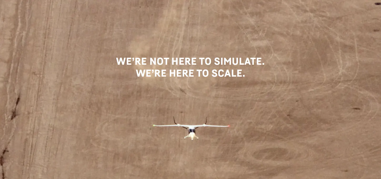 Electric aircraft flying over open desert: built to scale